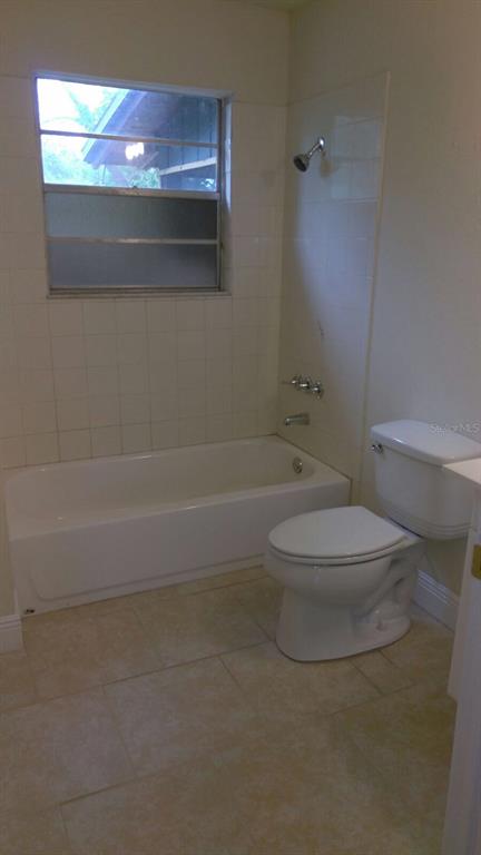 140 East 12th Street Apopka, FL 32703 - Photo 9 of 13 a bathroom with a toilet and a shower