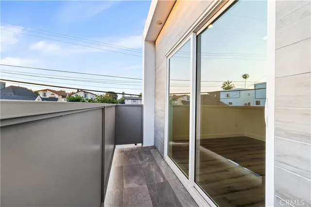 a view of a balcony from an empty room