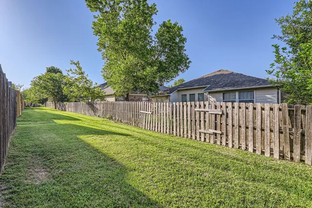 a view of a backyard with plants and garden