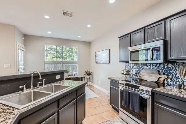 a kitchen that has a sink and a stove