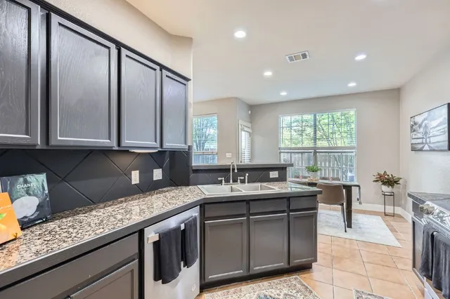 a kitchen with stainless steel appliances granite countertop sink stove and cabinets