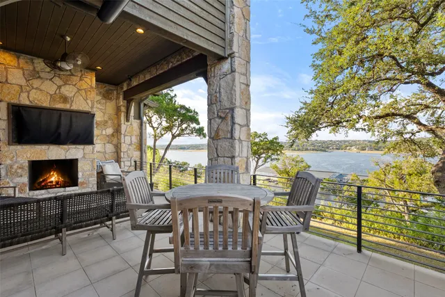 a view of a patio with a dining table and chairs