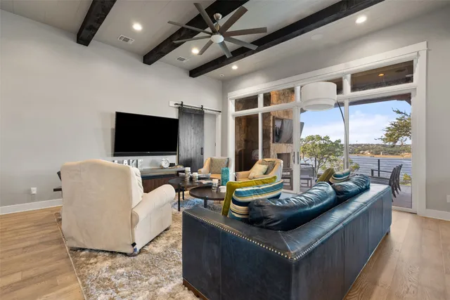 a kitchen with stainless steel appliances granite countertop a stove a refrigerator a kitchen island a table and chairs in it