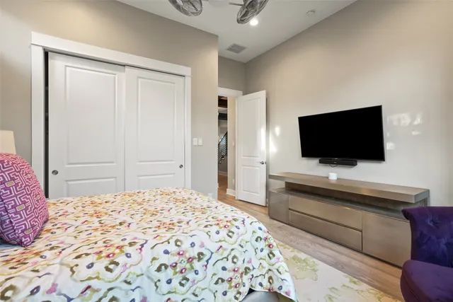 a bedroom with a bed couch and window