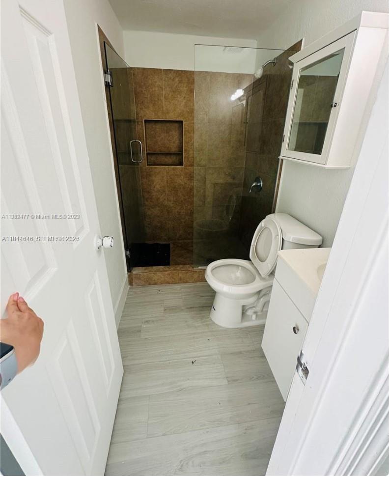 2215 Northwest 33rd Street Miami, FL 33142 - Photo 11 of 19 a bathroom with a toilet and a shower