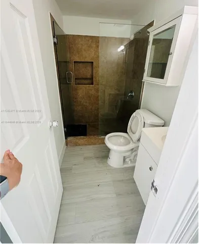a bathroom with a toilet and a shower
