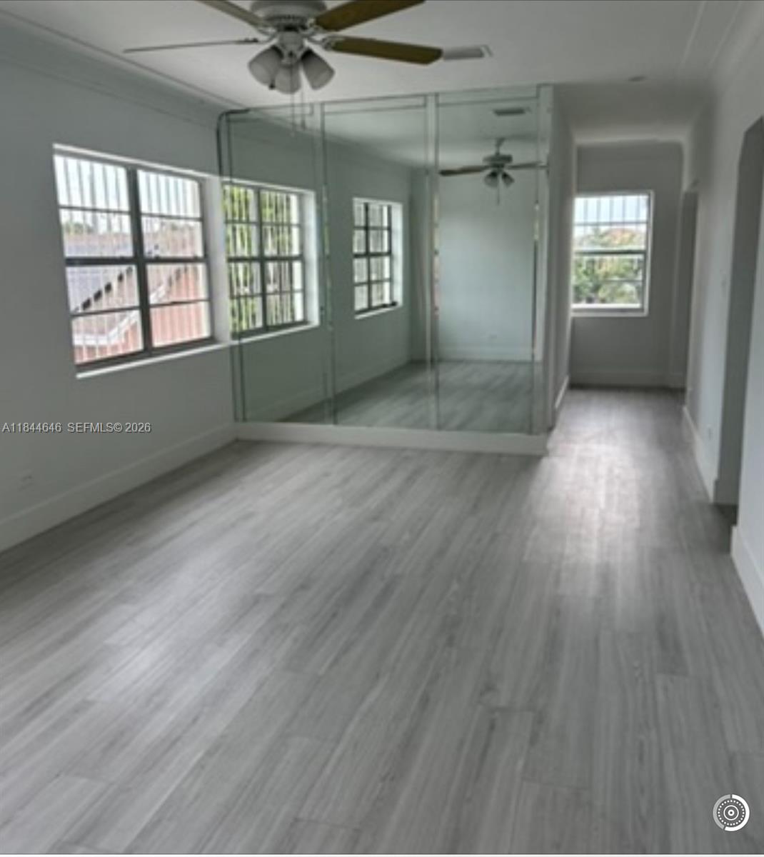 2215 Northwest 33rd Street Miami, FL 33142 - Photo 15 of 19 wooden floor in an empty room with a window