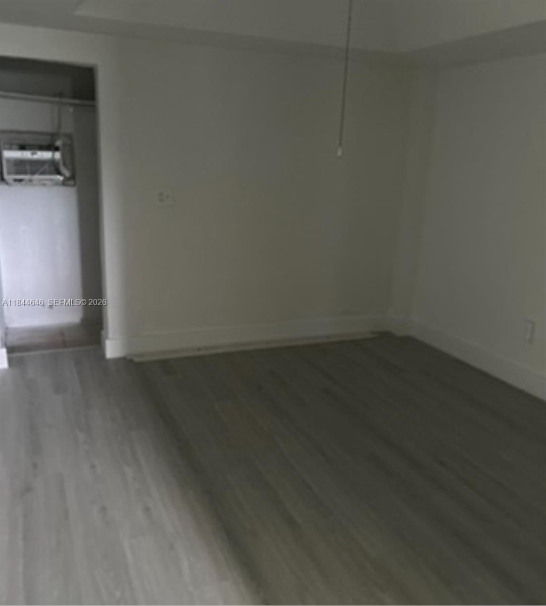 2215 Northwest 33rd Street Miami, FL 33142 - Photo 16 of 19 a view of a room with wooden floor and cabinets