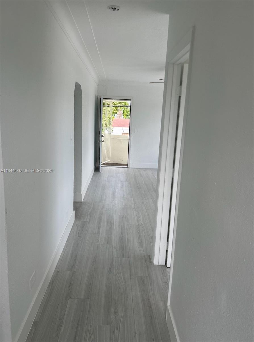2215 Northwest 33rd Street Miami, FL 33142 - Photo 19 of 19 an empty room with wooden floor and windows