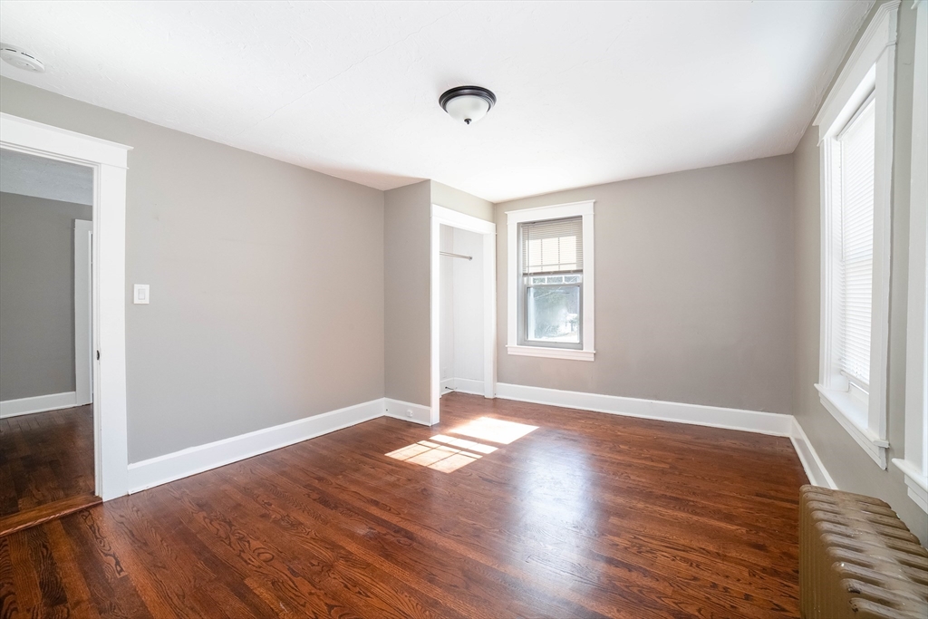 5 Maple Avenue, Unit 2 Oxford, MA 01537 - Photo 19 of 22 an empty room with wooden floor and windows