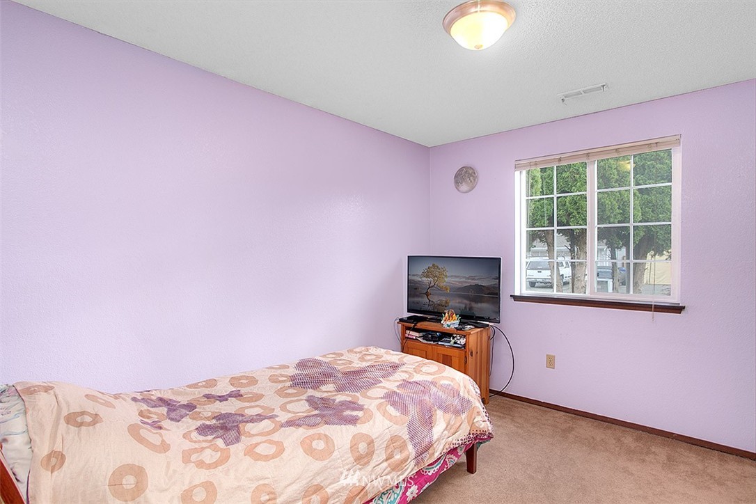 1722 225th Street Southeast Bothell, WA 98021 - Photo 12 of 19 a bedroom with a bed and a flat screen tv