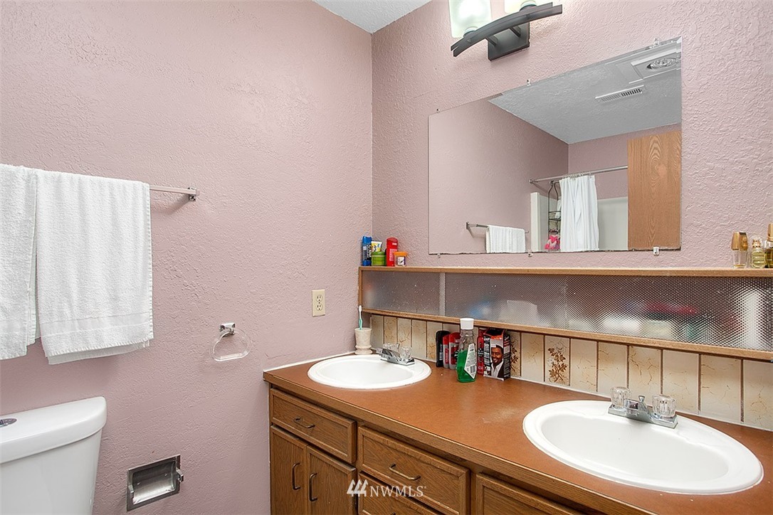 1722 225th Street Southeast Bothell, WA 98021 - Photo 13 of 19 a bathroom with a sink toilet and a mirror