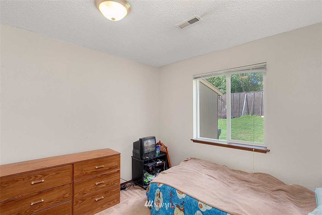 1722 225th Street Southeast Bothell, WA 98021 - Photo 15 of 19 a bedroom with a bed and window