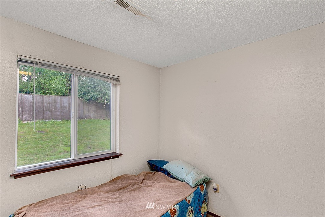 1722 225th Street Southeast Bothell, WA 98021 - Photo 16 of 19 a bedroom with a bed and a window