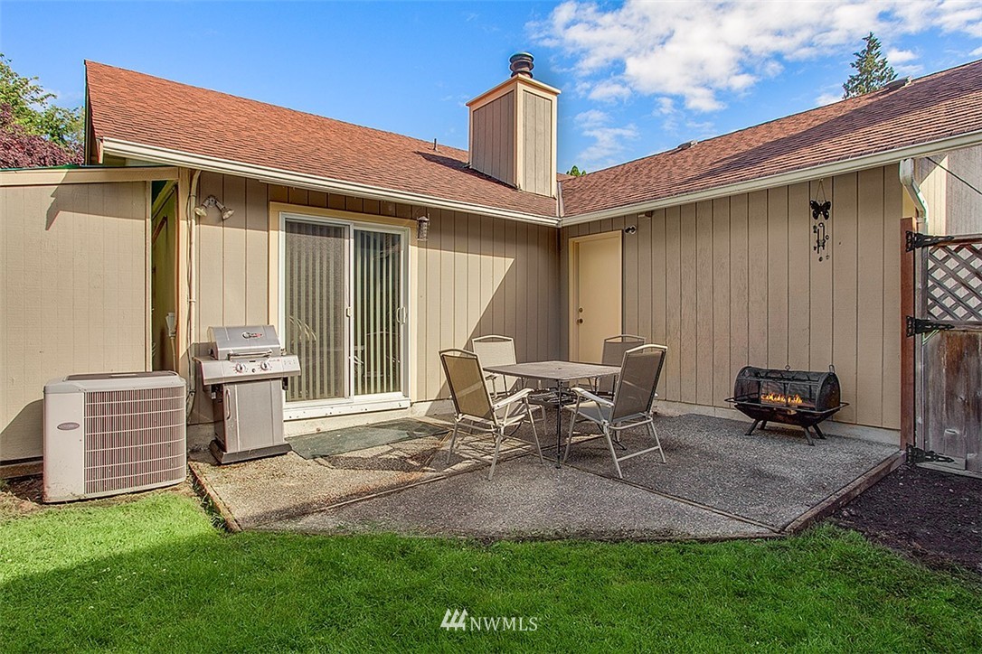 1722 225th Street Southeast Bothell, WA 98021 - Photo 18 of 19 a backyard of a house with table and chairs