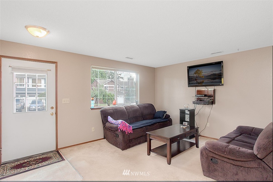 1722 225th Street Southeast Bothell, WA 98021 - Photo 3 of 19 a living room with furniture and a flat screen tv
