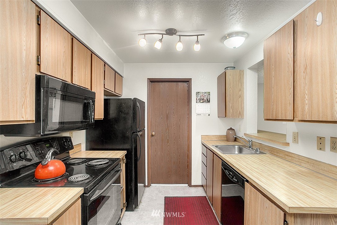 1722 225th Street Southeast Bothell, WA 98021 - Photo 6 of 19 a kitchen with stainless steel appliances a sink stove and refrigerator