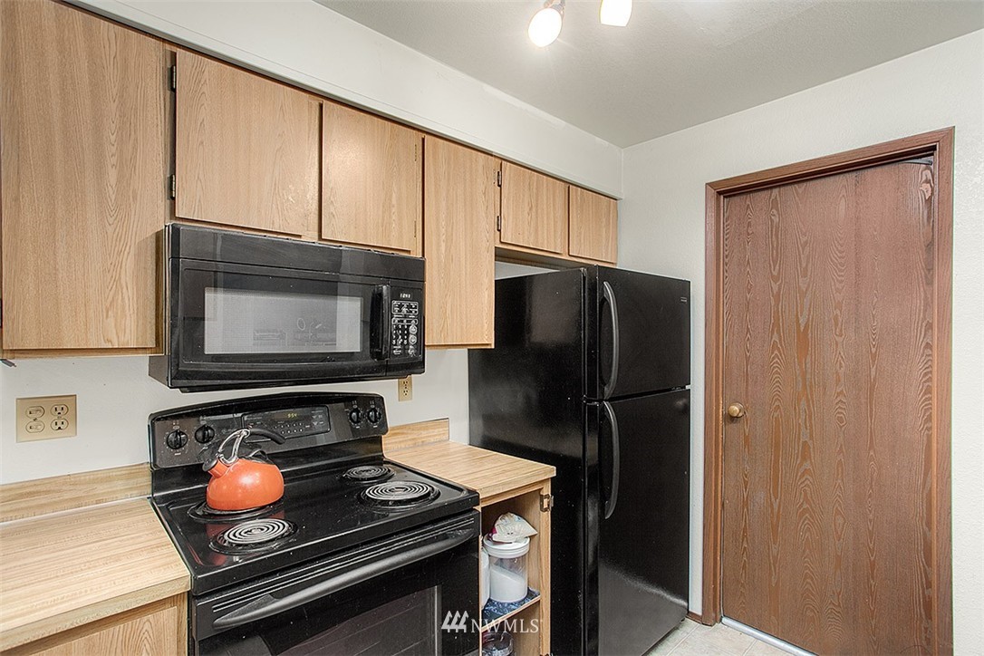 1722 225th Street Southeast Bothell, WA 98021 - Photo 7 of 19 a kitchen with stainless steel appliances granite countertop a refrigerator stove and microwave