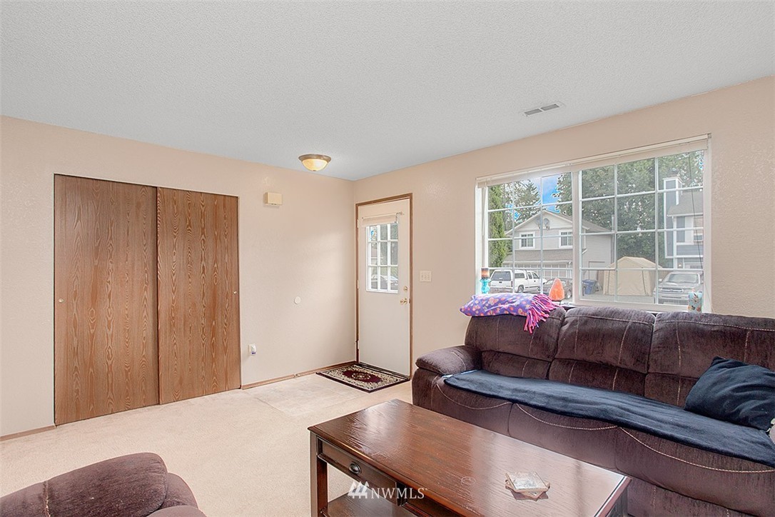 1722 225th Street Southeast Bothell, WA 98021 - Photo 9 of 19 a living room with furniture and a window