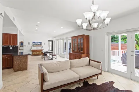a living room with furniture kitchen and a chandelier