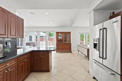a kitchen with stainless steel appliances granite countertop a refrigerator and sink