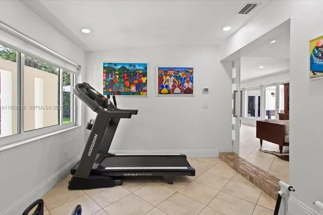 a room with gym equipment and a large window