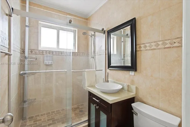 a bathroom with a toilet a sink and mirror