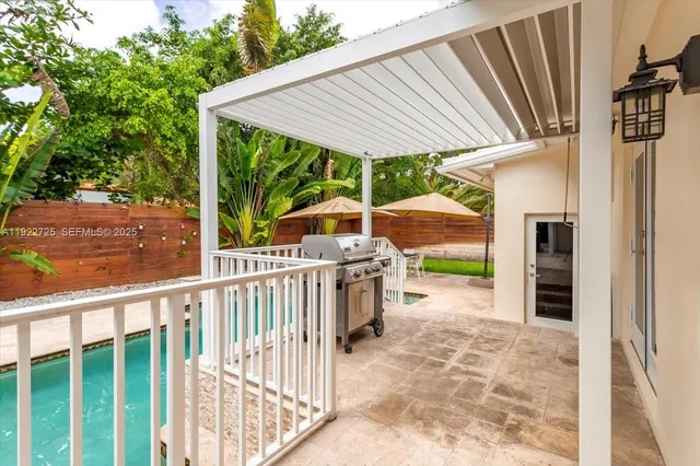 a view of a house with a yard and potted plants
