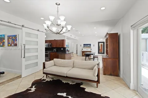 a living room with furniture wooden floor and a chandelier