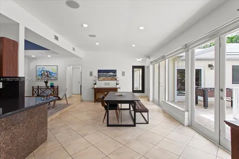 a living room with furniture a table and large windows