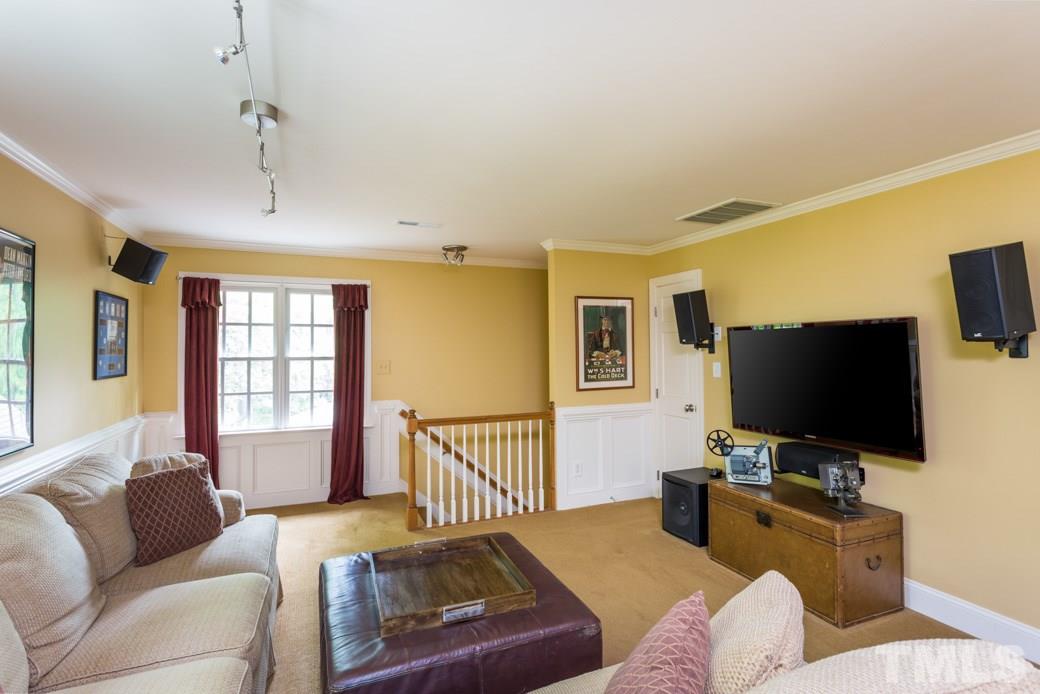 8613 Cold Springs Road Raleigh, NC 27615 - Photo 22 of 25 a living room with furniture and a flat screen tv