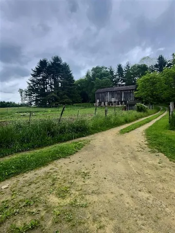 a view of a yard and front view of a house