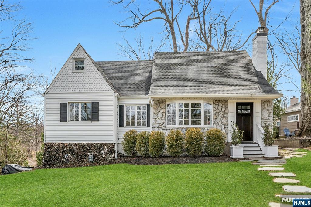 a front view of a house with a garden
