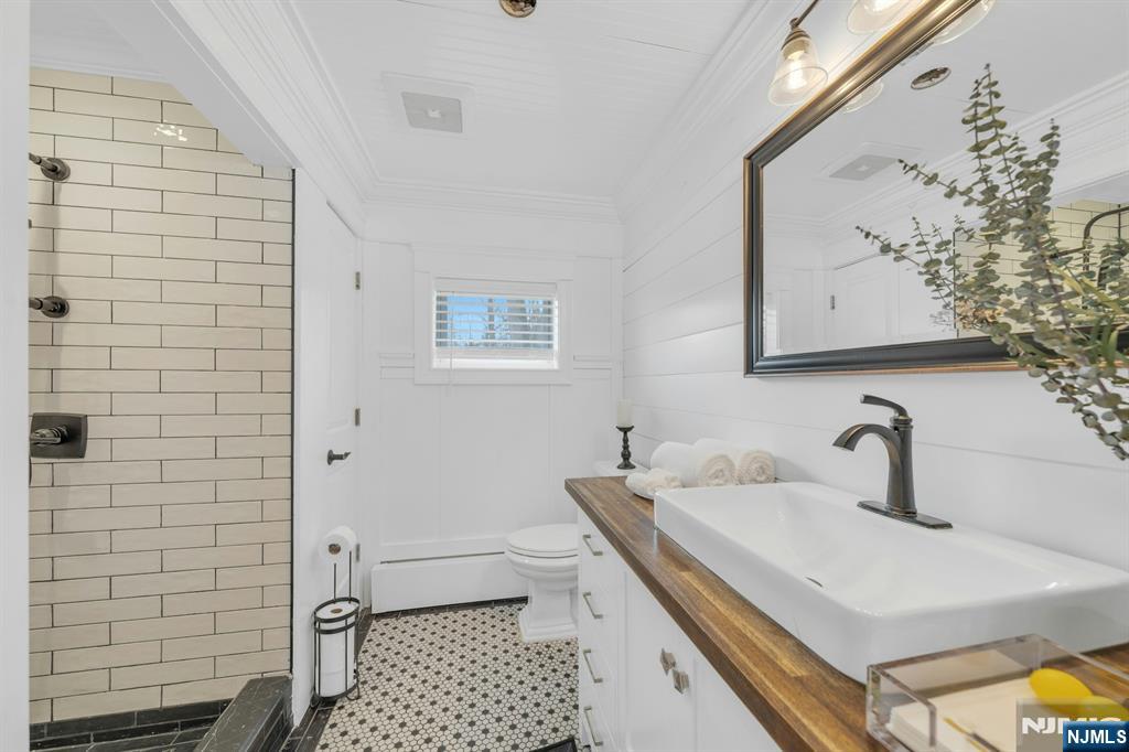8 Glenwood Road Denville, NJ 07834 - Photo 12 of 37 a bathroom with a sink a toilet and shower