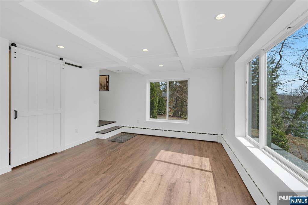 8 Glenwood Road Denville, NJ 07834 - Photo 21 of 37 a view of an empty room with a window and wooden floor