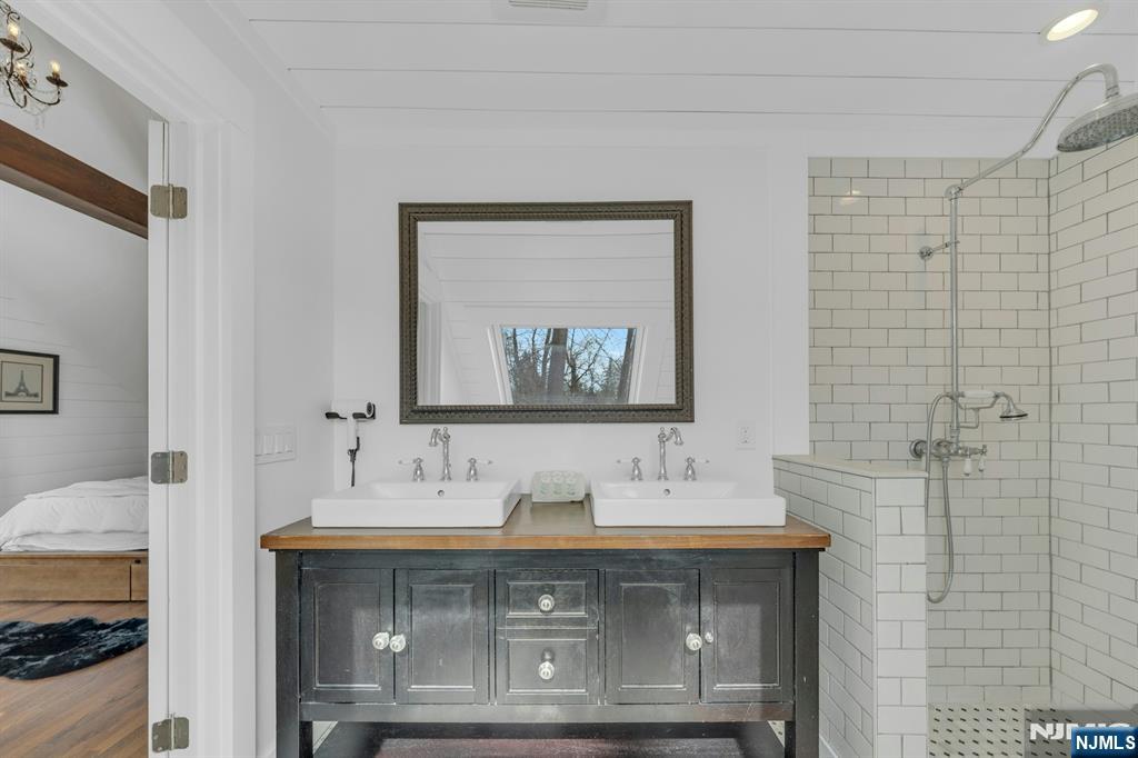 8 Glenwood Road Denville, NJ 07834 - Photo 24 of 37 a en suite bathroom with a granite countertop sink a mirror and a