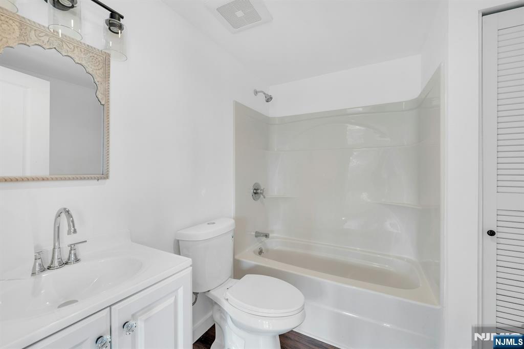 8 Glenwood Road Denville, NJ 07834 - Photo 26 of 37 a bathroom with a bathtub shower sink vanity mirror and toilet