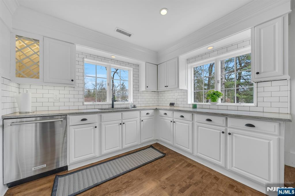8 Glenwood Road Denville, NJ 07834 - Photo 10 of 37 a kitchen with granite countertop white cabinets white appliances wooden floor and a window
