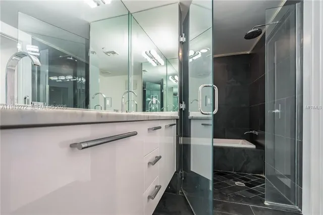a bathroom with a mirror and a shower