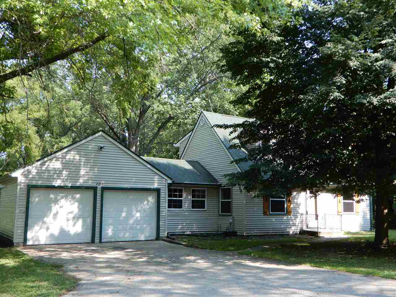 2304 Mill Road Cherry Valley, IL 61016 - Photo 1 of 20 a front view of a house with a yard and garage