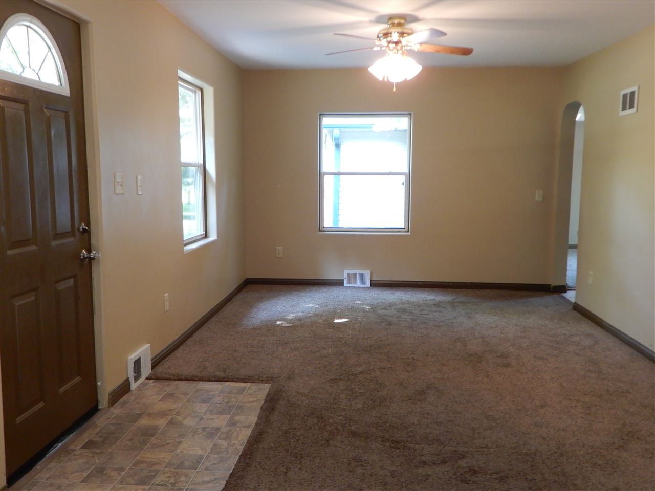 2304 Mill Road Cherry Valley, IL 61016 - Photo 2 of 20 an empty room with windows and chandelier fan