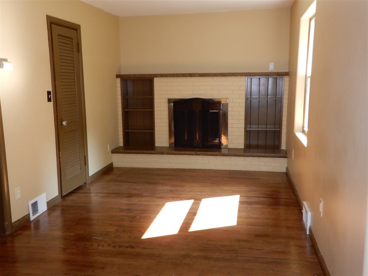 2304 Mill Road Cherry Valley, IL 61016 - Photo 3 of 20 a view of an empty room with wooden floor and a window