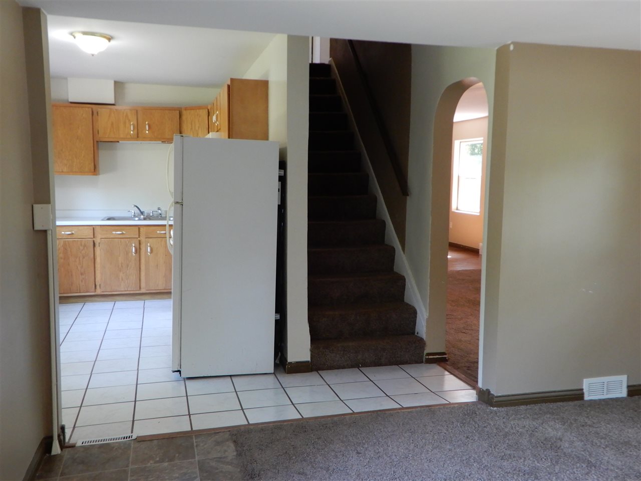 2304 Mill Road Cherry Valley, IL 61016 - Photo 7 of 20 a view of a kitchen with wooden cabinets and entryway
