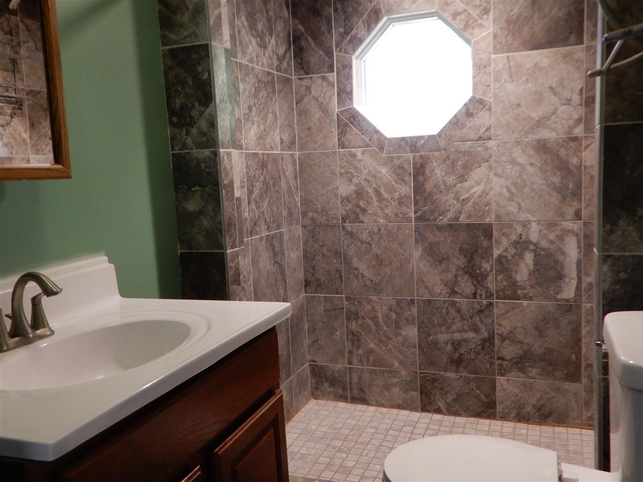 2304 Mill Road Cherry Valley, IL 61016 - Photo 8 of 20 a bathroom with a sink toilet and shower
