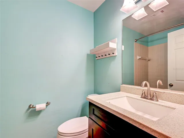 a bathroom with a sink vanity and a mirror