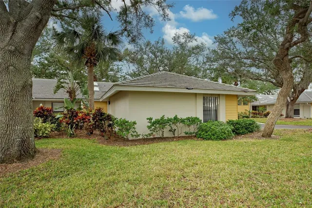 a front view of a house with a tree