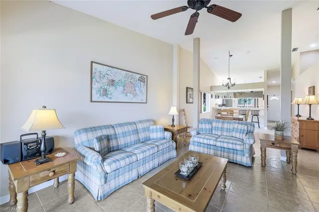 a living room with furniture and a lamp