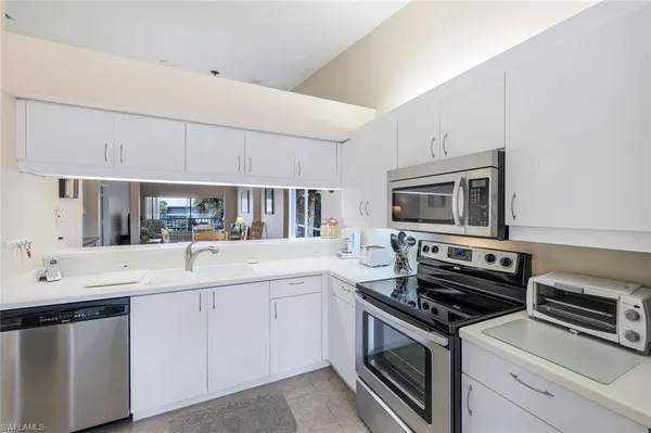 a kitchen with stainless steel appliances a sink stove and cabinets
