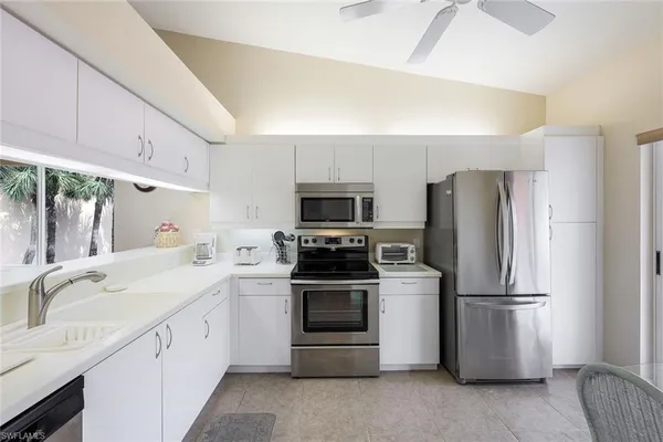 a kitchen with a refrigerator sink and stove