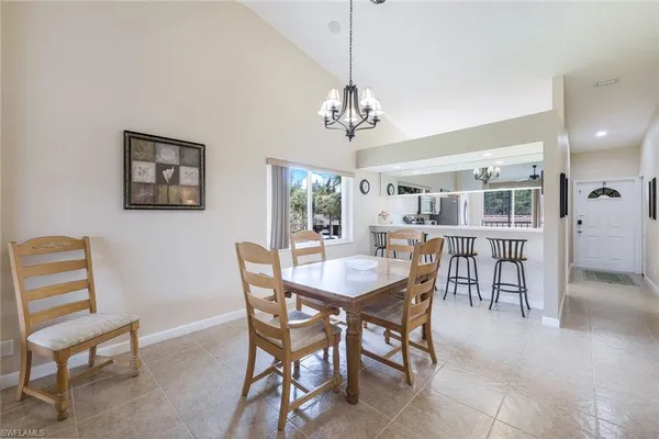 a view of a dining room with furniture and a chandelier